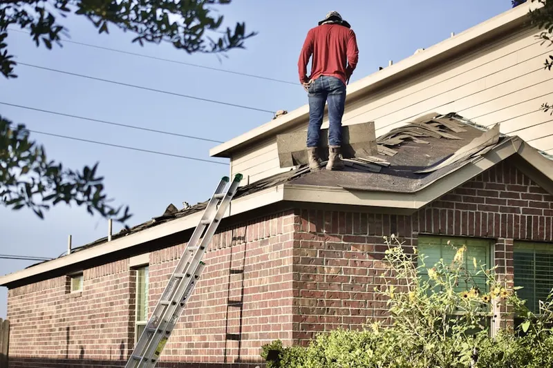 Professional roofer working on a residential roof in Lexington Leas